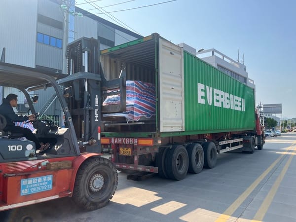SINOSUN folder gluer machine being loaded into a container for global shipping